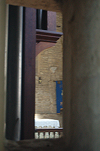 View through the squint in the north aisle into the chancel May 2011